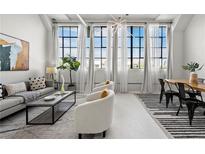 Bright, spacious living room with large windows, modern decor, and hardwood floors, perfect for relaxing or entertaining at 881 Memorial Se Dr # 307, Atlanta, GA 30316