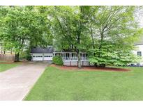 Charming home with well-maintained lawn, a two-car garage, and inviting front porch at 511 Pine Springs Se Trl, Marietta, GA 30067