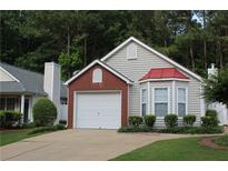 Charming home showcasing a well-manicured lawn, brick accents and a bay window at 1132 Britley Park Ln Ln, Woodstock, GA 30189