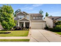 Charming two-story home with a well-manicured lawn, attached two car garage and appealing curb appeal at 122 Grove View Rd, Woodstock, GA 30189