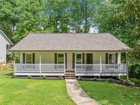 Charming single-story home boasts a welcoming front porch and beautifully landscaped yard at 3310 Southlake Ln, Cumming, GA 30041