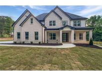 Charming two-story home featuring a stone and brick facade with black trim accents at 1465 Leach Dr, Lawrenceville, GA 30045