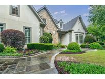 Charming home with well-manicured landscaping and stone walkway at 5318 Brooke Farm Dr, Dunwoody, GA 30338