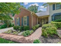Charming brick home featuring a landscaped yard and inviting front porch with a stone bench at 1236 Whitlock Ridge Sw Dr, Marietta, GA 30064