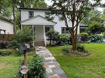 Charming two-story white home with landscaped front yard and stone walkway leading to the entrance at 3330 W Shadowlawn Ne Ave, Atlanta, GA 30305