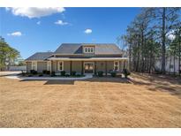 Charming one story home with a large front yard, covered porch, and mature trees at 8007 Wishaw Ct, Winston, GA 30187