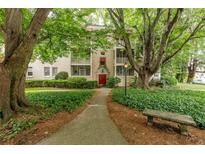 Inviting exterior of a multi-Gathering home with a red door, beautiful trees, and a landscaped walkway at 2230 Peachtree Ne Rd # A-3, Atlanta, GA 30309