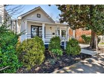 Charming bungalow featuring a well-manicured front yard and inviting front porch at 32 Howell Se St, Atlanta, GA 30312