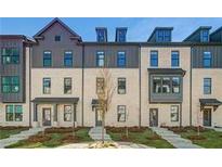 Charming townhome featuring classic architectural details and a professionally landscaped front yard at 525 Rubato Knl, Mcdonough, GA 30253