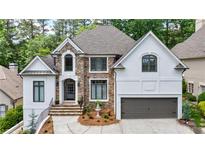 Charming two-story home featuring stone and stucco exterior with manicured landscaping at 1021 Wetherby Way, Alpharetta, GA 30022