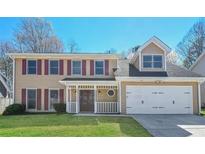 Charming two-story home with a manicured lawn and cozy front porch at 1416 Emerald Pine Ct, Lawrenceville, GA 30043