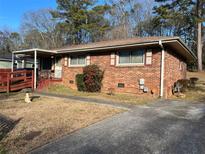 Charming single-story brick home with a covered front porch and well-maintained landscaping at 8118 Sw Collier Sw St, Covington, GA 30014