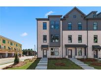Modern townhome exterior with brick facade, gray accents, and well-maintained landscaping at 533 Rubato Knl, Mcdonough, GA 30253