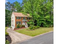 Charming two-story brick home with green shutters, landscaped yard, and inviting curb appeal at , Marietta, GA 30064