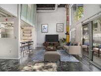 Bright living room with high ceilings, modern furnishings, and sliding glass doors to the outside at 195 Arizona Ave # 179, Atlanta, GA 30307