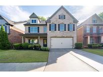Charming two-story brick home with a well-manicured front yard and a two-car garage at 2800 Tuscany Park Dr, Lawrenceville, GA 30043