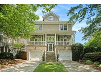 Inviting two-story home featuring a brick foundation and a charming front porch with dual ceiling fans at 1126 Francis Ne St, Atlanta, GA 30319