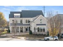 Beautiful two-story home featuring large windows, covered porch, dormers, and professional landscaping at 1005 Coleman Place Dr, Roswell, GA 30075