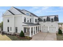 Gray exterior featuring a large two-car garage and covered porch at 1005 Coleman Place Dr, Roswell, GA 30075