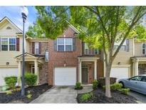 Charming townhouse with brick facade, attached garage, and well-maintained front yard landscaping at 3379 Thornbridge Dr, Powder Springs, GA 30127