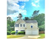 Charming two-story home with blue shutters and attached two-car garage at 6005 Pattingham Dr, Roswell, GA 30075