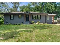 Charming brick home with manicured lawn and stylish wood porch columns at 1643 Flintwood Se Dr, Atlanta, GA 30316