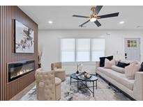 Modern living room featuring a fireplace, wood-slat accent wall, contemporary decor, and abundant natural light at 1643 Flintwood Se Dr, Atlanta, GA 30316