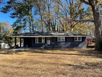 Charming single-story home featuring a brick facade, covered carport, and well-maintained front yard at 4905 Sweet Valley Sw Rd, Mableton, GA 30126