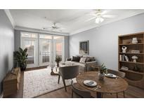 Inviting living room with ample natural light, neutral tones, ceiling fans, and stylish furnishings at 400 17Th Nw St # 1253, Atlanta, GA 30318