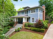Charming blue two-story home with a landscaped yard and a welcoming front porch, perfect for relaxing at 1020 Austin Ne Ave, Atlanta, GA 30307