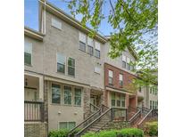 Townhome exterior featuring a mix of stone and brick facade, stairs lead to covered entrance at 3066 Quantum Ln # 24, Atlanta, GA 30341