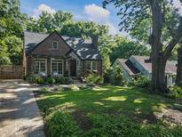 Charming brick home with a stone entrance, lush landscaping, and a welcoming front porch with seating at 978 Eden Se Ave, Atlanta, GA 30316