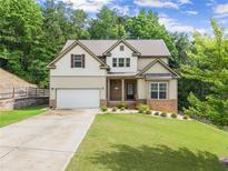 Charming two-story home featuring a well-manicured lawn, attached two car garage, and beautiful front yard landscaping at 275 Creek View Place, Canton, GA 30114