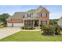 Charming two-story brick home with well-manicured lawn and two-car garage at 1221 Fountain Head Ct, Lawrenceville, GA 30043