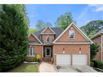 Charming brick home with manicured lawn and a two-car garage on a sunny day at 35 Kenmare Hall Ne, Atlanta, GA 30324