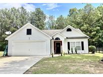 Charming single-story home with a manicured lawn, two-car garage, and inviting front entrance at 7113 Silver Mine Xing, Austell, GA 30168