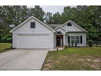 Charming single-story home with a well-manicured front yard and attached two car garage at 7113 Silver Mine Xing, Austell, GA 30168