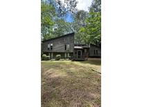 Contemporary-style home with a two-story façade, wood siding, front yard, and large windows at 361 Gordon Valley Sw Ln, Mableton, GA 30126
