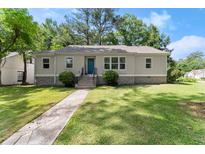 Charming home featuring a well-manicured lawn, complemented by a stone foundation and an inviting entrance at 1301 Eastridge Sw Rd, Atlanta, GA 30311