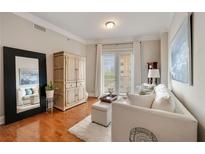 Bright living room featuring hardwood floors, plush seating, and a large mirror reflecting the space at 2277 Peachtree Ne Rd # 611, Atlanta, GA 30309