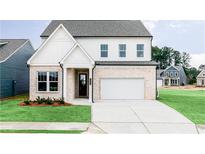 Charming two-story home with a white brick facade, a well-manicured lawn, and a two car garage at 417 Newland Way, Acworth, GA 30102