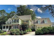Charming two-story home with a manicured lawn, attached two-car garage, and inviting front porch at 192 Chicopee Dr, Marietta, GA 30060