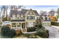 Charming two-story home boasts a manicured lawn, inviting front porch, and a convenient two-car garage at 192 Chicopee Dr, Marietta, GA 30060