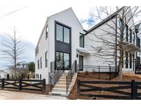 Striking exterior with modern design, black window accents, and a landscaped front yard at 101 Pearl St, Woodstock, GA 30188
