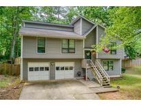 Charming two-story home with gray siding, a two-car garage, and a welcoming front porch at 1220 Wade Green Nw Cir, Acworth, GA 30102