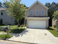 Charming two-story home with a brick-accented garage and well-maintained front yard at 6446 Grey Fox Way, Riverdale, GA 30296