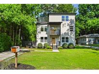 Modern two-story home with a charming front yard and a rooftop deck, perfect for enjoying the outdoors at 670 Parker Ave, Decatur, GA 30032