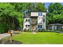Modern two story home with a yard, mailbox, and small porch with balcony at 670 Parker Ave, Decatur, GA 30032