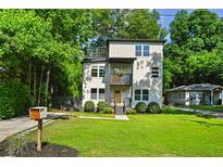 Charming two-story home with a modern design and inviting front yard and a bonus upper deck at 670 Parker Ave, Decatur, GA 30032