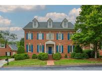 Beautiful two-story brick home with blue shutters and manicured front lawn at 3499 Paces Ferry Se Cir, Smyrna, GA 30080